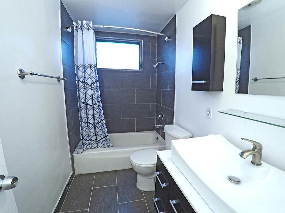 Bathroom features porcelain tiling and modern vessel sink
