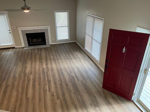 Living room with fireplace extra tall ceilings.