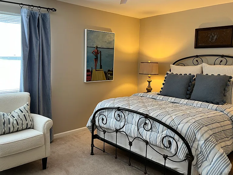 Second Bedroom upstairs includes Queen Bed, Chair and smart TV, plus walk-in closet.