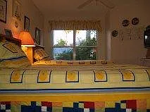 Guest room has two twin beds and many storage areas.