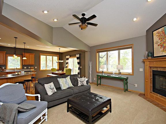 Spacious living room with gas fireplace, high ceilings and tons of natural light
