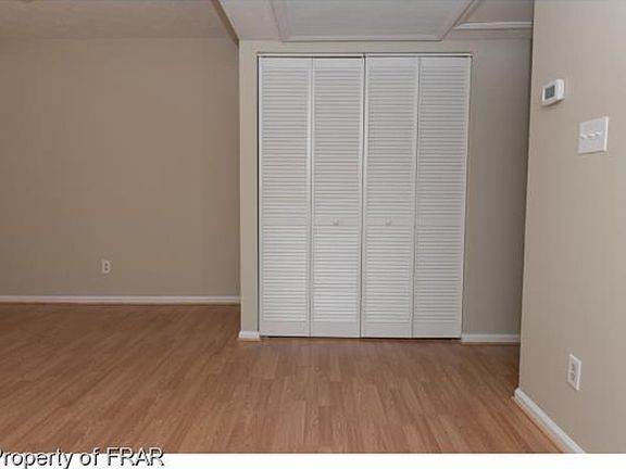 The hidden washer and dryer hookup is behind the bi-fold doors next to the water heater. The area accommodates a full-size set.
