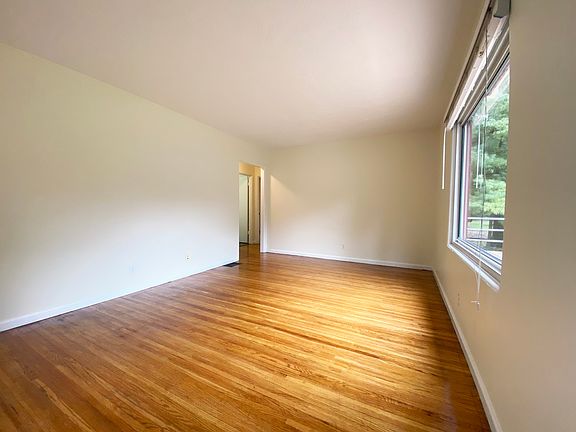 Living room, not staged, with beautiful hardwood floor, great light.