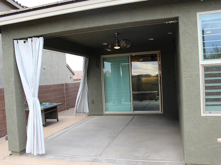 Covered patio with recessed lighting and fan. Access to the family room and master suite.