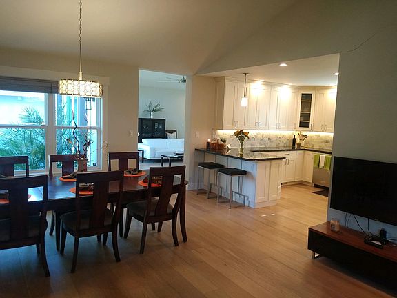 Kitchen and dining room viewed from living room. Family room in distance.