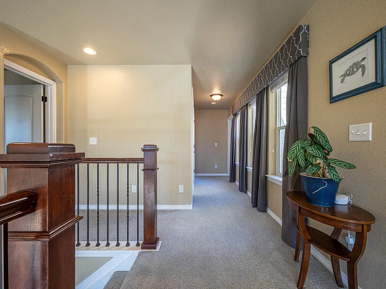 upstairs hallway. Primary to the left, down the hall is bathroom and 2 bedrooms. To the right is laundry and another bedroom