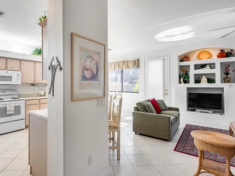 Living room, kitchen, bar counter, & dining room areas