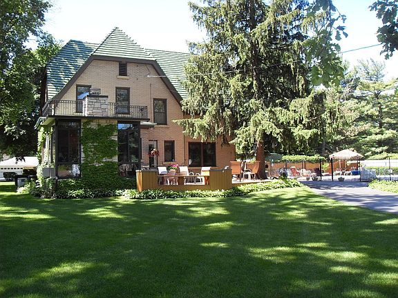 BACK YARD SHOWING PATIO, AND FENCED, HEATED, IN-GROUND POOL