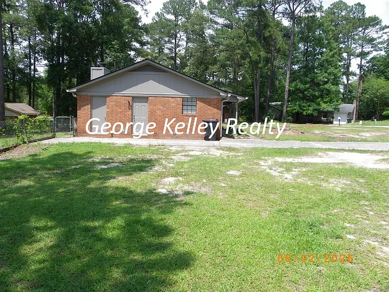 Side view with exterior door to Storage room and 2nd exterior door to Laundry room