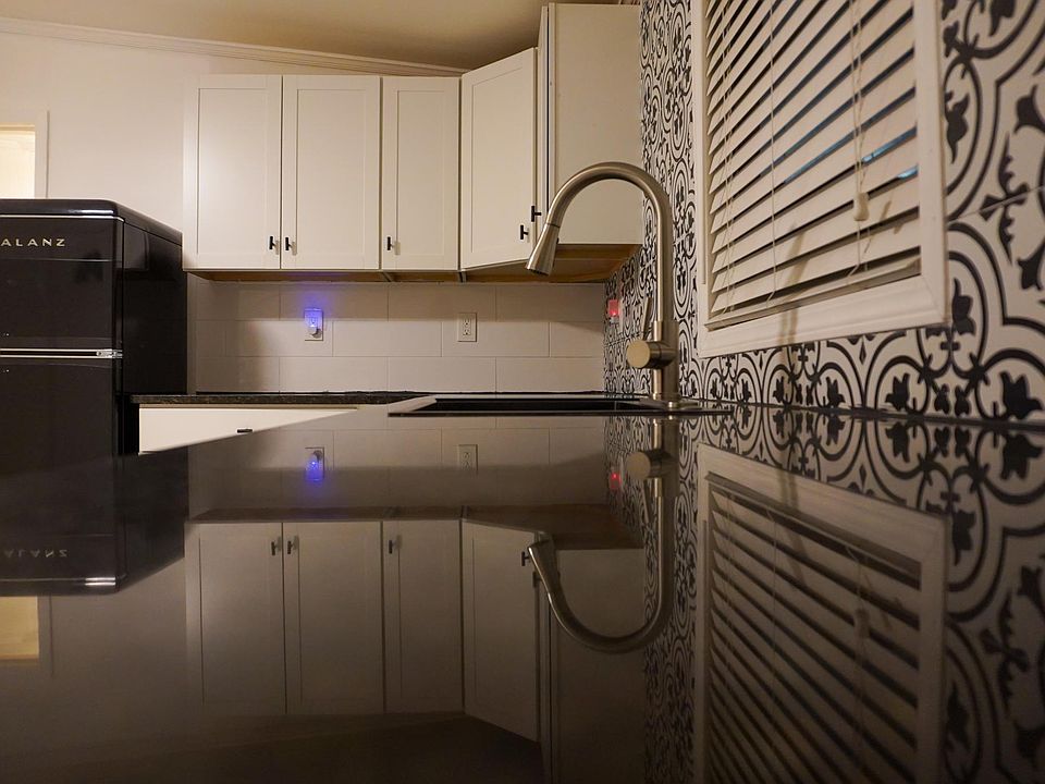brand new kitchen with black appliances. Includes flat induction stove and retro-style refrigerator