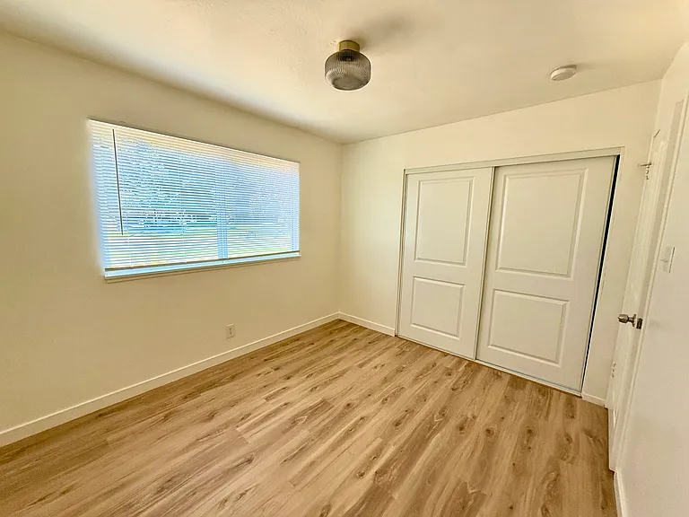 alternate view of bedroom A, with sliding door closet
