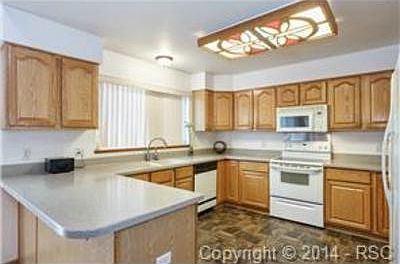 Light and open kitchen with Corian countertops.  All kitchen app
