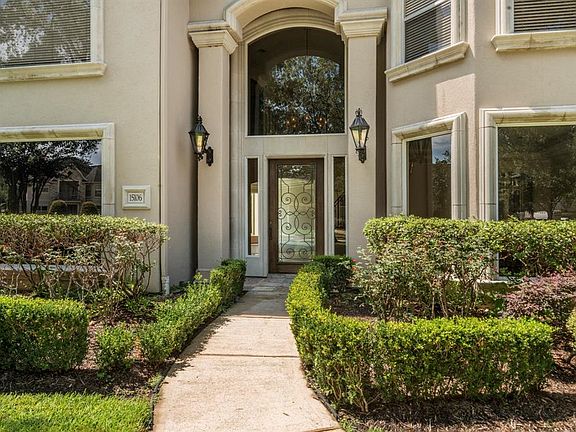 Attractive stucco exterior, large windows, impressive two story entry with gas lanterns.