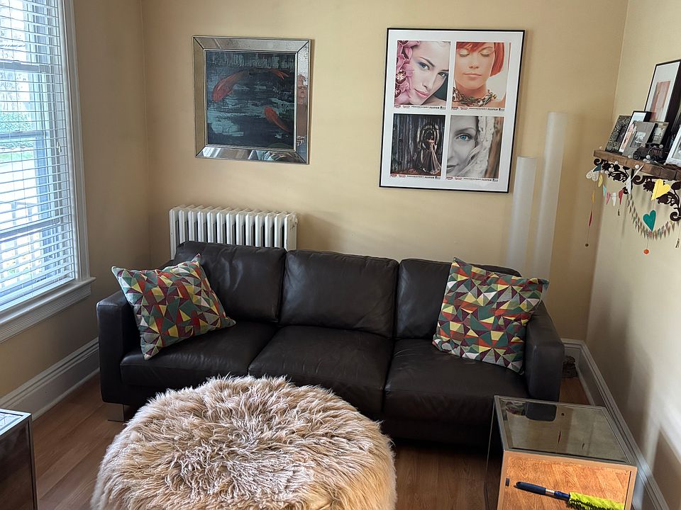Living room with furniture from previous tenant. Living room is now vacant
