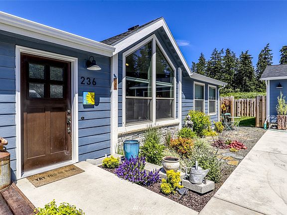 As you approach, colorful landscape and new, high end, front door.