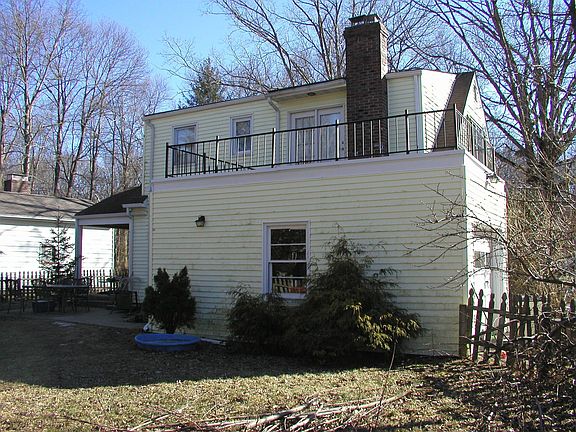 Back of home with "deck" and garage