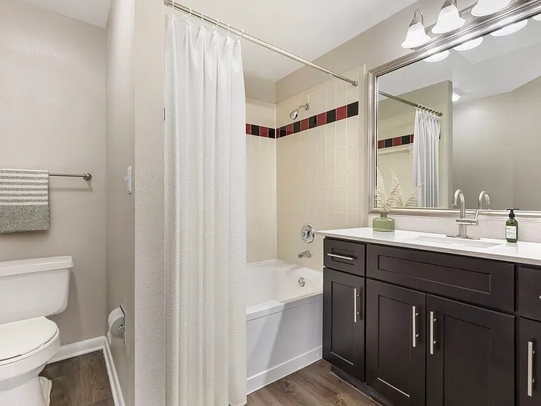 Classic Package I bath with white quartz countertop, espresso cabinetry, and hard surface flooring