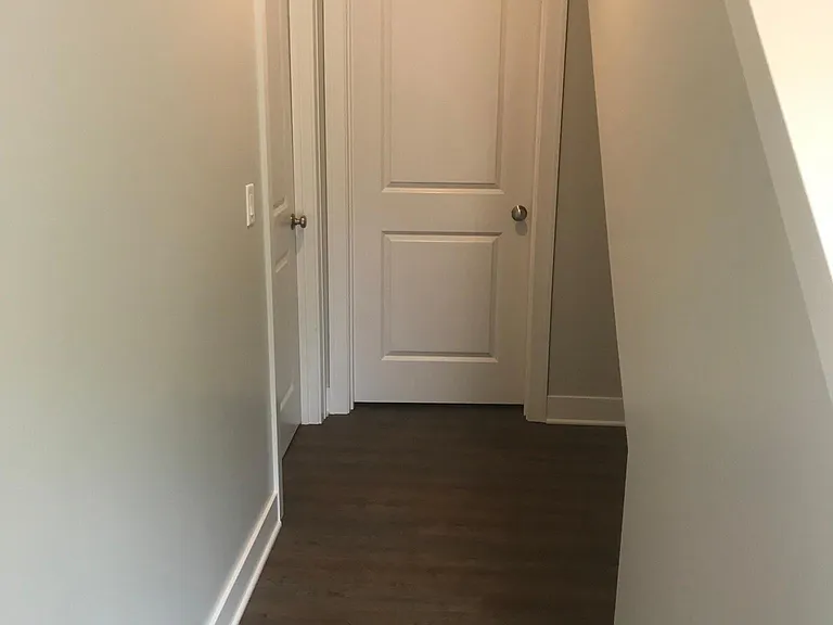 Lower level hall. Bedroom #3 to the left, through door ahead is to the washer and dryer utility room.