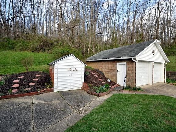 Home Features a 2 Car Garage and Shed