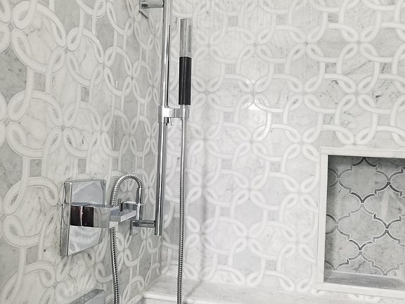 Exquisite Kohler fixtures in full bathroom shower