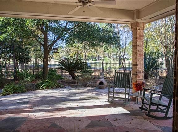 Watch the golfers from one of the two Covered Flagstone patios .