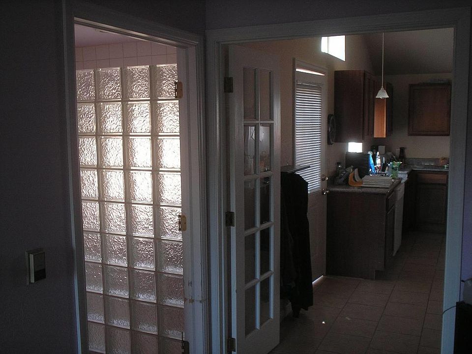 Glass block shower wall, pedestal sink.