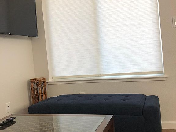 All windows have privacy & light-filtering shades installed; the ottoman has built in storage.
