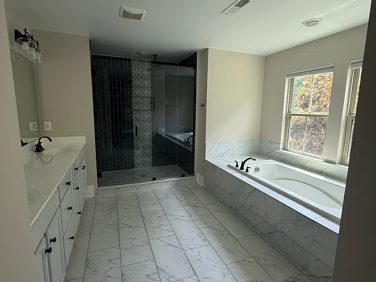 Remodeled en-suite bath featuring designer finishes and a spa-like feel.
