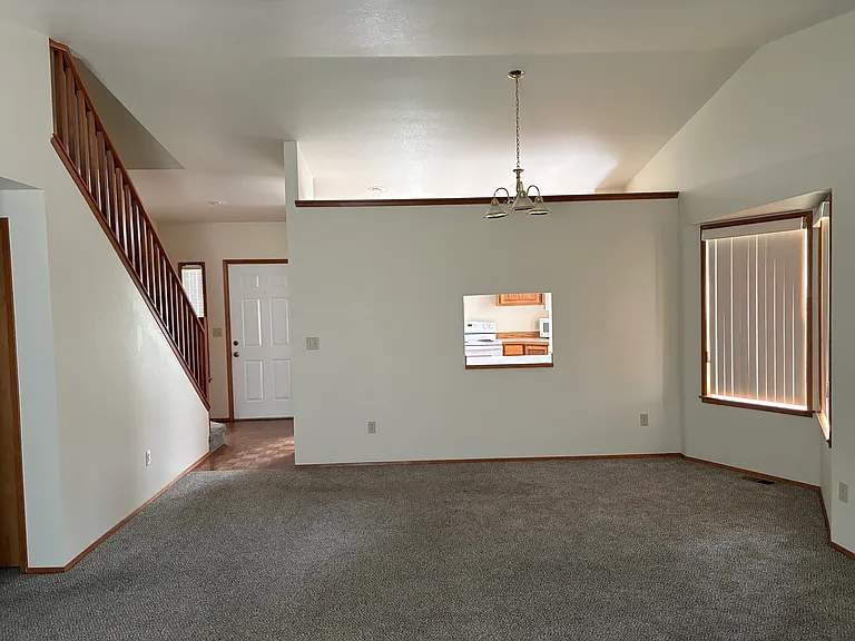 Dining area with window into kitchen.