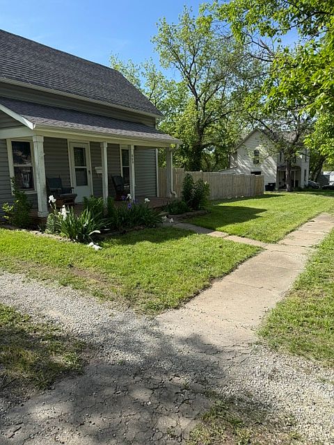 Front of home with beautiful flowers