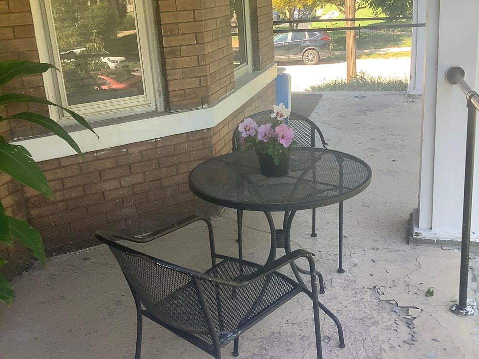 Front porch exclusively used by an apartment with wrought iron furniture