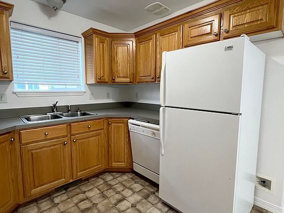 Kitchen cupboards, dishwasher, and refrigerator layout.