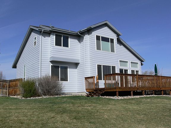 Huge backyard boasts freshly oiled redwood deck perfect for entertaining