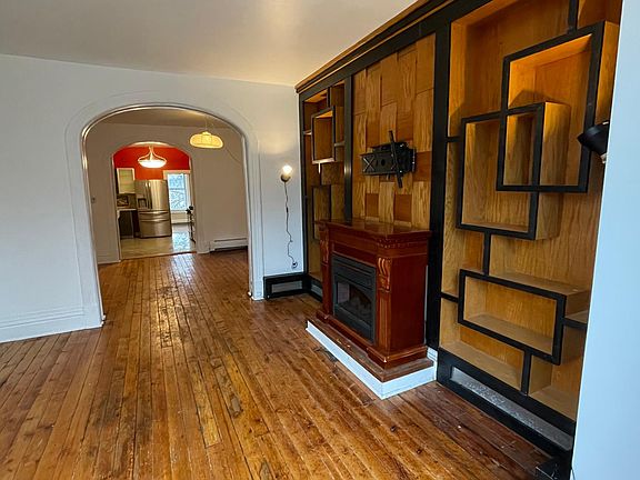 Living room with custom built in shelving unit and electric fireplace