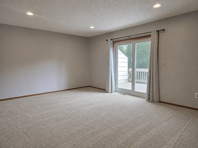 Living room with walkout to deck and backyard