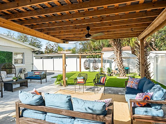 Outdoor Pergola with lots of seating, and outdoor TV for entertainment