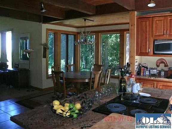 Looking out each window you would think you are in a tree house. Not to worry, this home is filled with natural light. The view out the arched window is the Strait of Juan de Fuca.