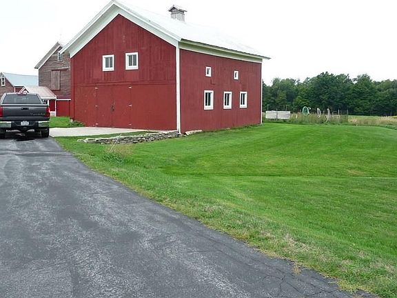 This barn has been updated and is used for a garage and lots of storage and a work shop. Garden out back.