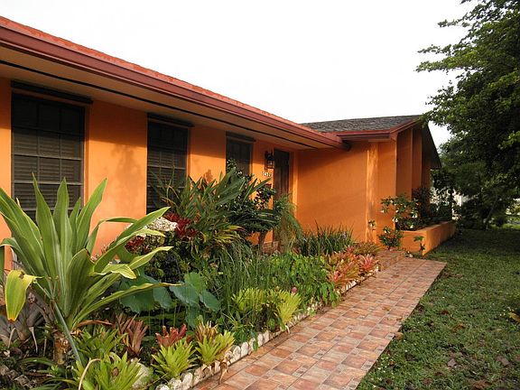 Walkway to front door next to fish pond