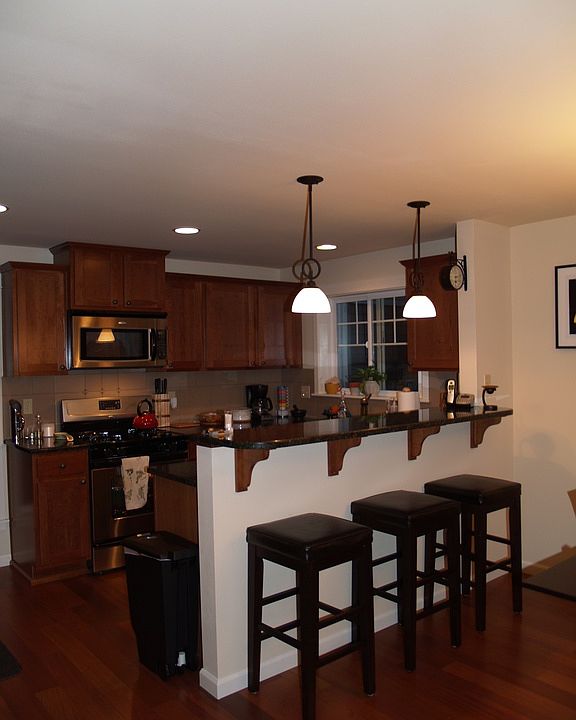 Kitchen off living room area with stainless steel appliances