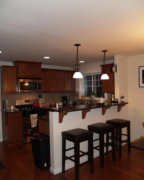Kitchen off living room area with stainless steel appliances