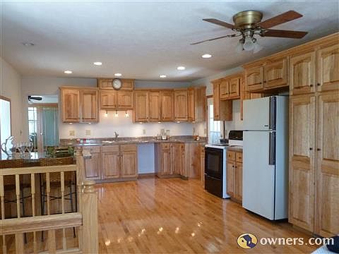 Kitchen area has maple hardwood floor