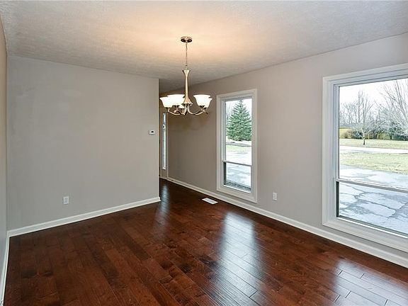 Pictured: Dining room off the Foyer entry. Behind the photographer is the kitchen, kitchen table area, access to screened in porch, loft staircase, laundry, and more!