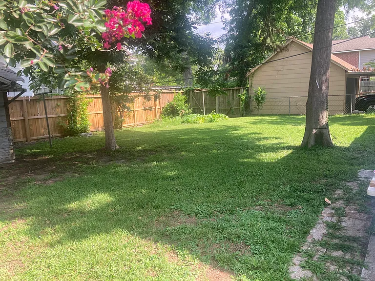 Backyard - well shaded. Privacy fence on three sides. Fenced all the way around. Utility shed.