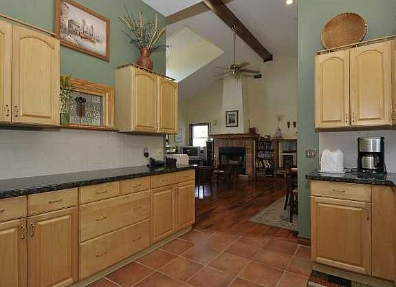 Large kitchen with granite counters and maple cabinets