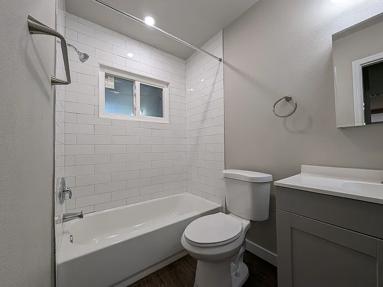 Recently renovated bathroom with soaking tub and privacy glass windows