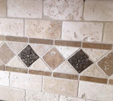 travertine and metal tile backsplash