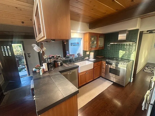 kitchen looking to front door to the left and hallway down to bedroom and bathroom on the right
