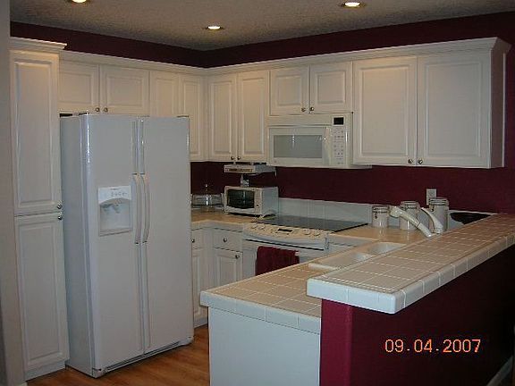 Kitchen with upgraded white cabinets, tile countertops 