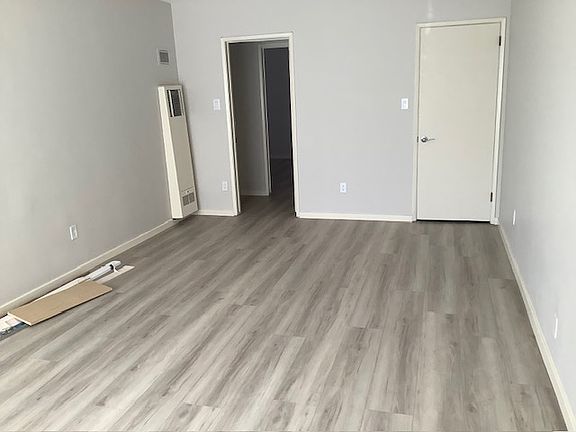Living room from front door. Closet door on the right, hallway door on the left.